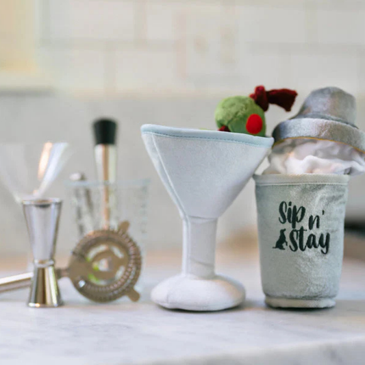 Dog toy martini glass and cocktail shaker with 'Sip n' Stay' text on a marble surface.