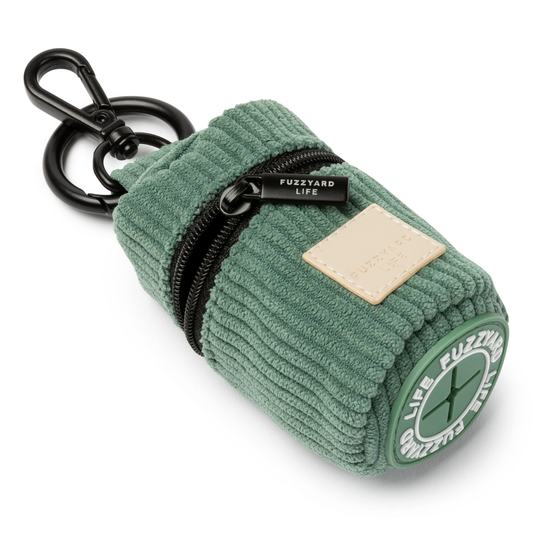 Myrtle green corduroy poop bag dispenser keychain pouch with a black zipper on a white background