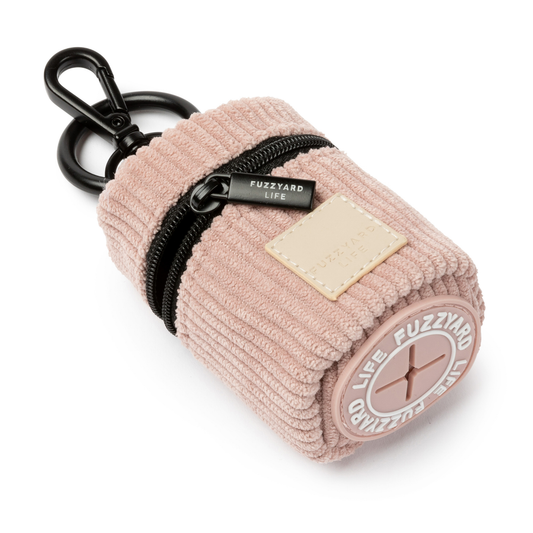 Soft blush corduroy poop bag dispenser keychain pouch with a black zipper on a white background