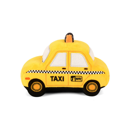 Yellow taxi-shaped dog toy with 'TAXI' and 'NYC' text on a white background